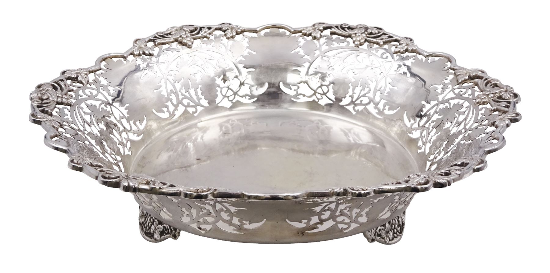 Modern silver Britannia standard fruit bowl, of lobed circular form, with applied and pierced fruiting vine decoration throughout, upon three bracket feet, hallmarked 1966, maker's mark BSC