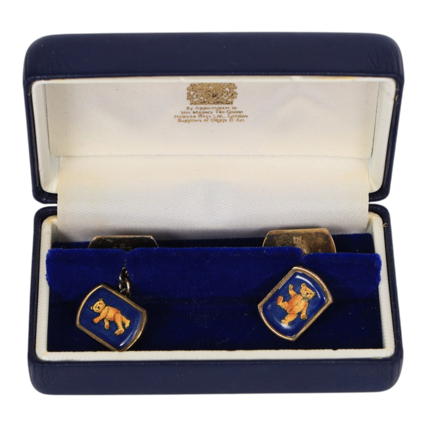 Three pairs of silver cufflinks, comprising jockeys cap pair, Halcyon days teddy bear enamel pair and a 1995 enamel pair, together with two other pairs of novelty cufflinks