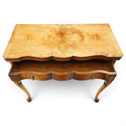 Quality early 20th century Queen Anne design walnut card table, rectangular book-matched veneer fold-over and swivel top with scalloped edge enclosing baize-lined interior, fitted with shaped frieze drawer with brass pear-drop handles over shaped apron, raised on C-scroll carved cabriole supports with pad feet