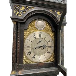 Edward Golland of Retford (Notts) - mid-18th century 8-day carved oak longcase c1760 , with a stepped caddy top and blind fret, break arch hood door flanked by carved pilasters with brass capitals,  trunk with a carved break arch toped door on a carved plinth with applied skirting and feet, brass dial with matching steel hands, silvered and engraved dial centre and chapter ring, with seconds dial and calendar aperture, four seasons spandrels and boss to the arch with makers name, four pillar rack striking movement, striking the hours on a bell. With weights and pendulum.            
Edward Golland is recorded as working in Retford during the late 18th century.