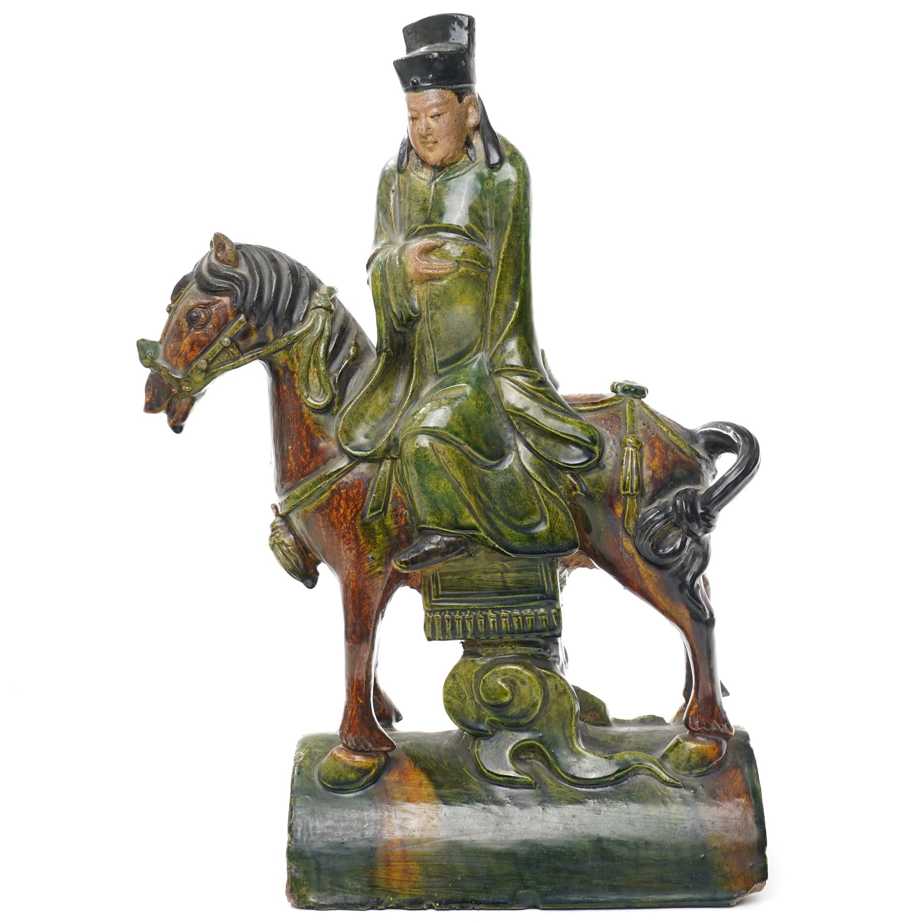 Chinese Ming dynasty Sancai Glazed Roof Tile, modelled as a dignitary on horseback, dressed in a long robe with voluminous folds, wearing an official's cap, upon a half cylinder tile, H40cm