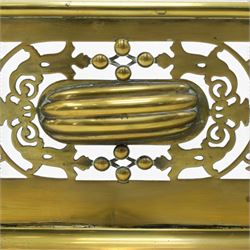 Victorian pierced brass fire fender, the pierced scrolling gallery of Aesthetic taste with applied roundels and protruding lobed mounts, raised on bun feet