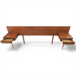Austinsuite - mid 20th century teak headboard with bedside cabinets and matching  mirrored dressing table, the headboard with floating single drawer bedsides raised on a single tapering support, the dressing table with attached tilting mirror, above rectangular top with kneehole and two banks of two drawers, raised on tapering supports

Headboard H 84cm, D 40cm, W 229cm, W between bedsides 151cm 
Dressing table H 113cm D 44cm, W 149cm, H to underside of dresser 61cm