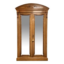 Alex Mackenzie & Co. Glasgow - Large late 19th century Scottish birds eye maple double wardrobe, arched pediment carved with trailing foliage and mounted with carved cartouche, projecting cornice over a banded frieze, two central mirror glazed doors enclosing hanging space and shelf, plinth base