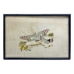 WW1 French embroidered silk picture of a British bi-plane in flight over fields firing its gun 25 x 37.5cm; ebonised frame
