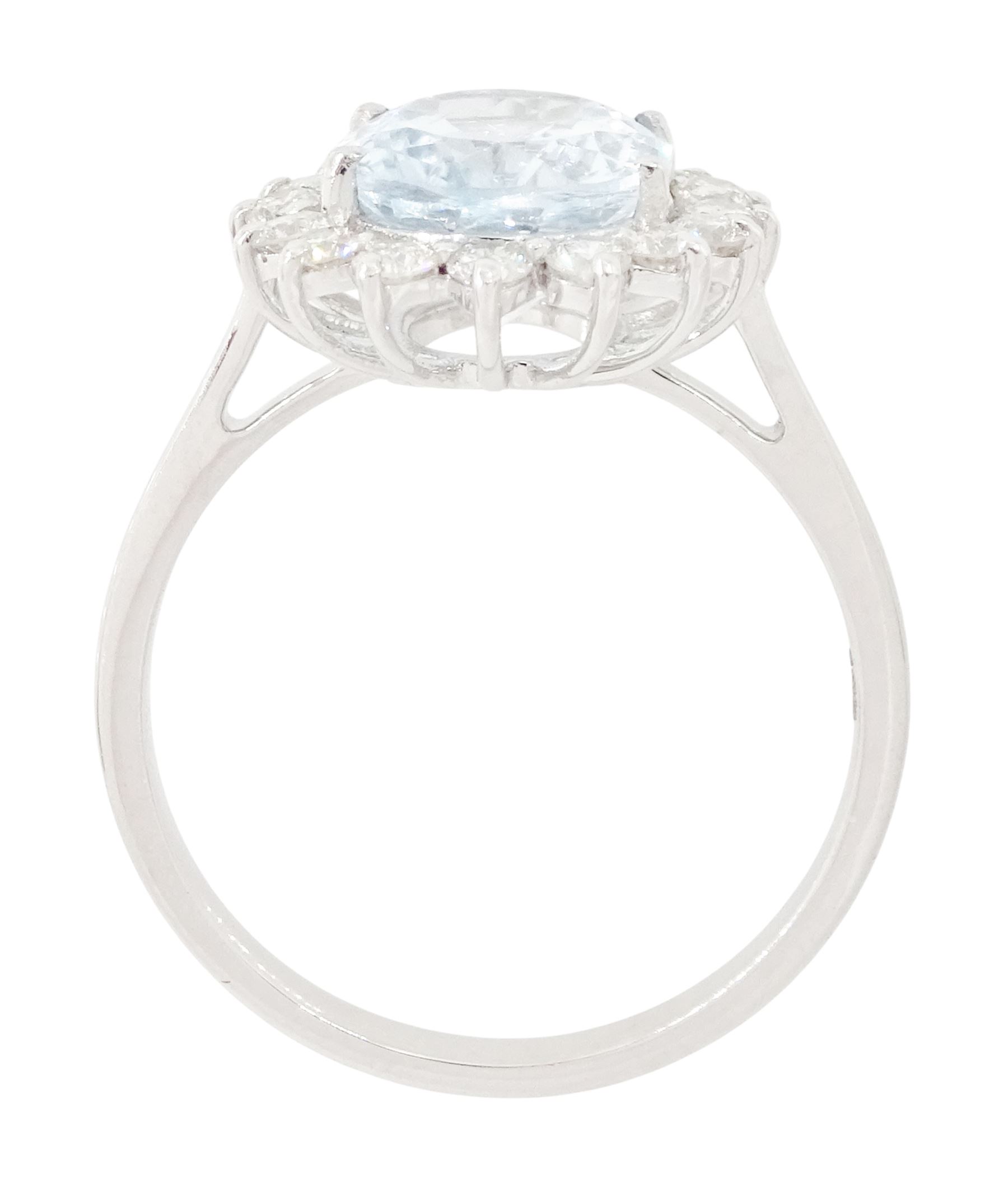 18ct white gold aquamarine and diamond cluster ring, single oval cut aquamarine of approx 2.25 carat, surrounded by sixteen round brilliant cut diamonds, stamped 18K, total diamond weight approx 0.50 carat