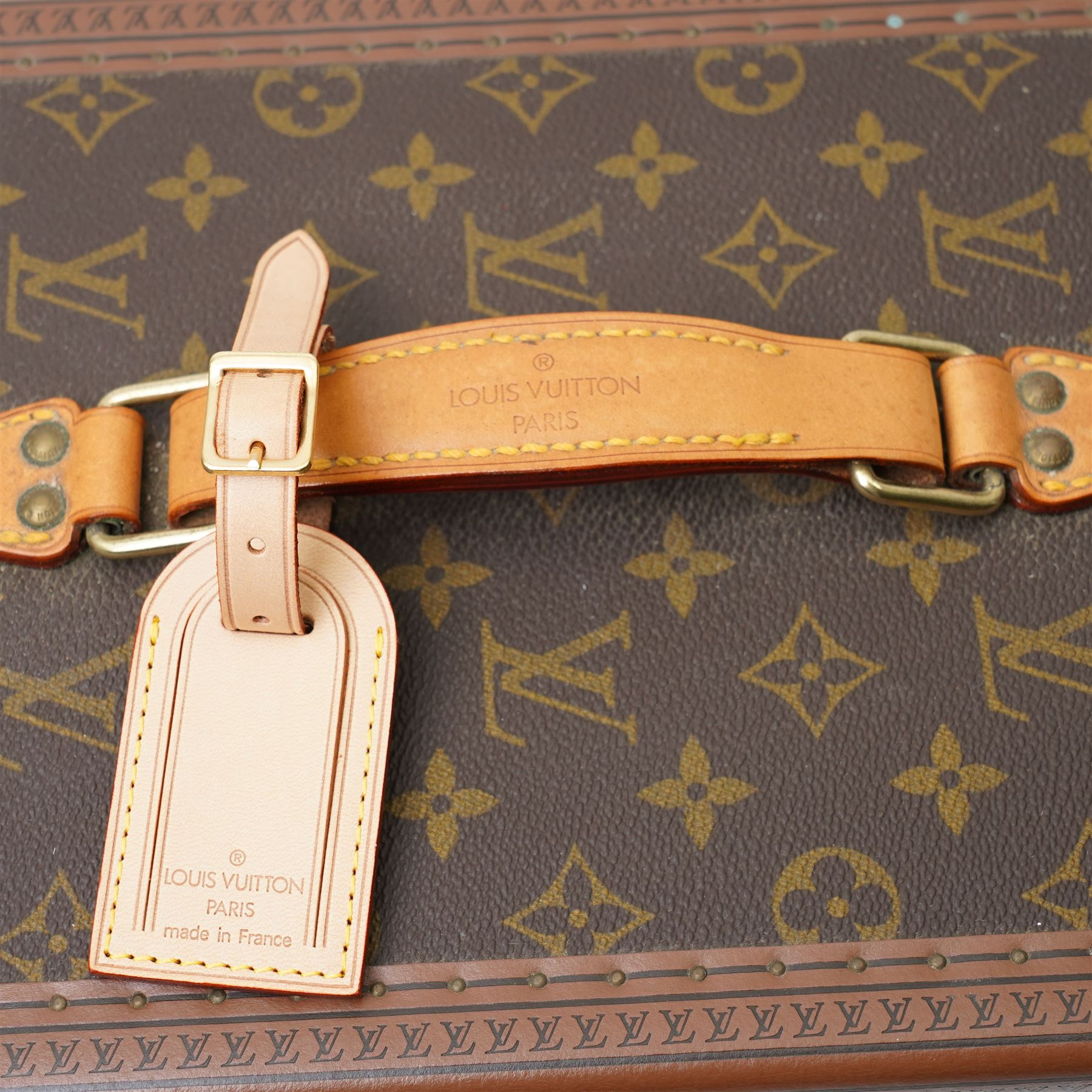Late-20th century Louis Vuitton monogram Boîte Flacons vanity coffret, monogram canvas with lozine trim and brass mounts, single front brass lock stamped Louis Vuitton with key code 1247413, the interior fitted with leather flacon retaining loops and lift-out lidded tray with leather handle, label to interior printed Louis Vuitton Paris serial number 1045768, together with two keys stamped with matching serial numbers to the lock and luggage tag, circa late 1990s-early 2000s