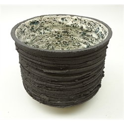  Stephanie Black (British, Contemporary) hand thrown textured vase, the interior decorated with a pale green, black and white speckled glaze, H15cm x D17cm   
