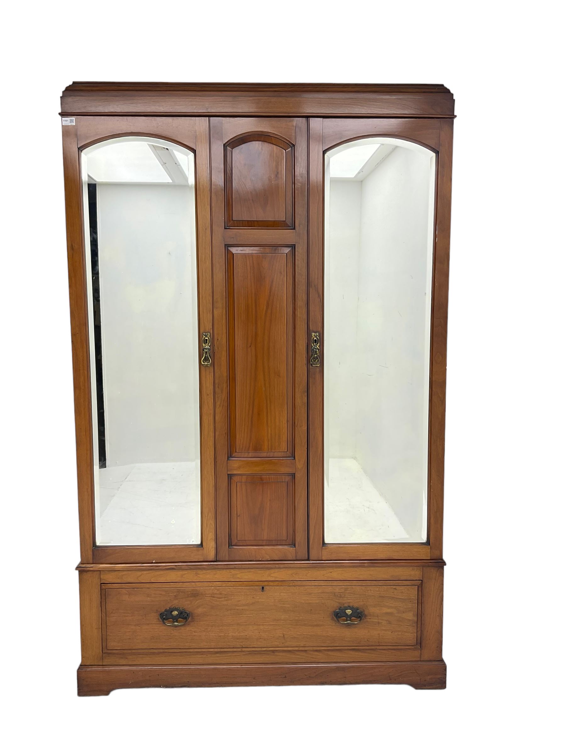 Edwardian walnut double wardrobe, fitted with two bevelled mirror panelled doors, single drawer to base