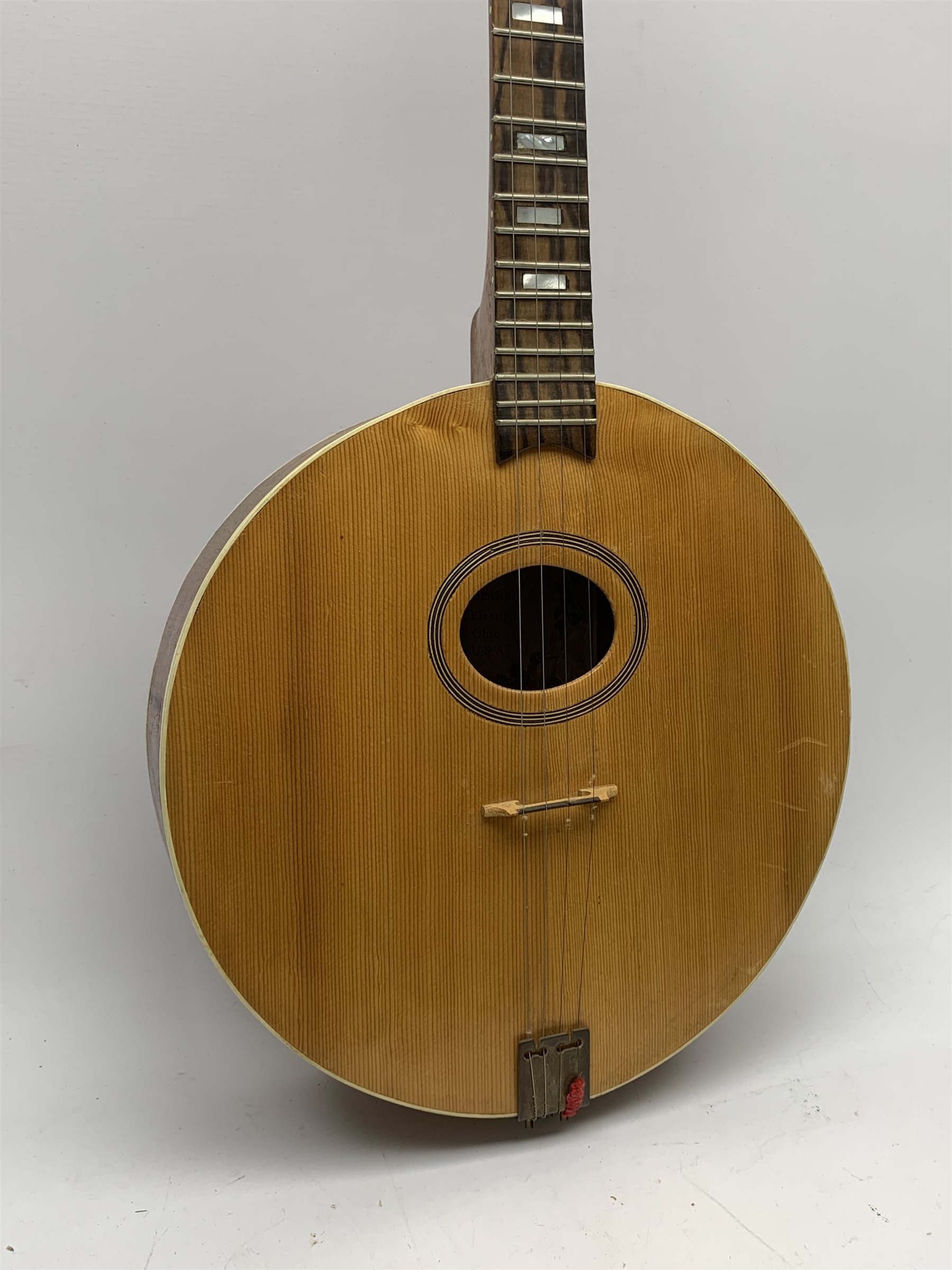 Four-string banjo guitar with mahogany circular back and sides and spruce top, mother-of-pearl inlaid fingerboard and headstock, bears humorous label 'Fender Bedpanjo', L95cm