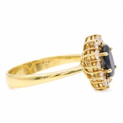 18ct gold sapphire and diamond cluster ring, single oval cut sapphire of approx 1.05 carat, surrounded by twelve round brilliant cut diamonds, stamped 750, total diamond weight approx 0.25 carat