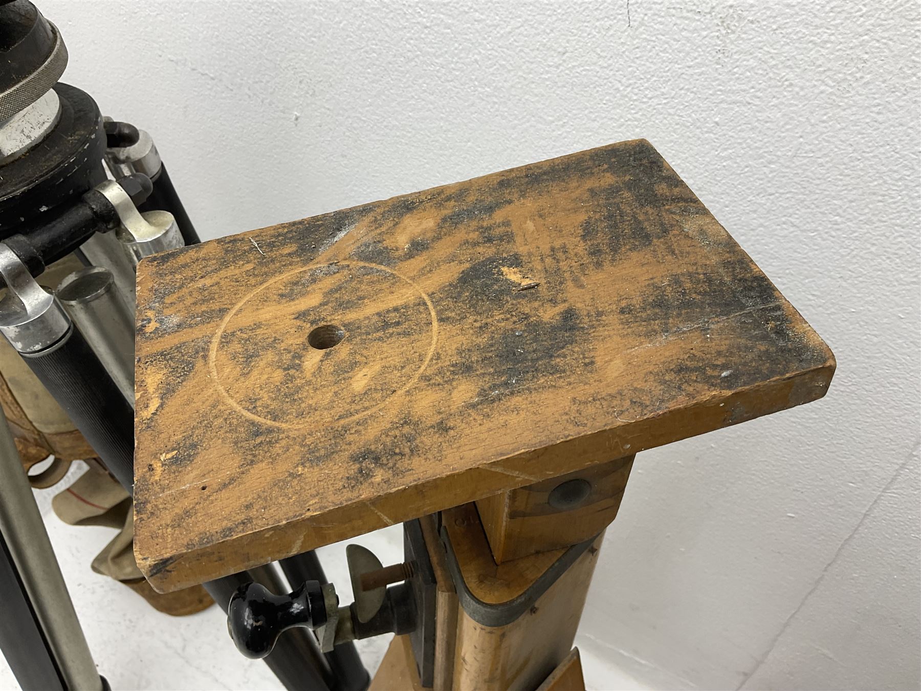 Three wooden adjustable tripods for plate cameras, together with a Linhof of Munchen metal tripod in a canvas case 