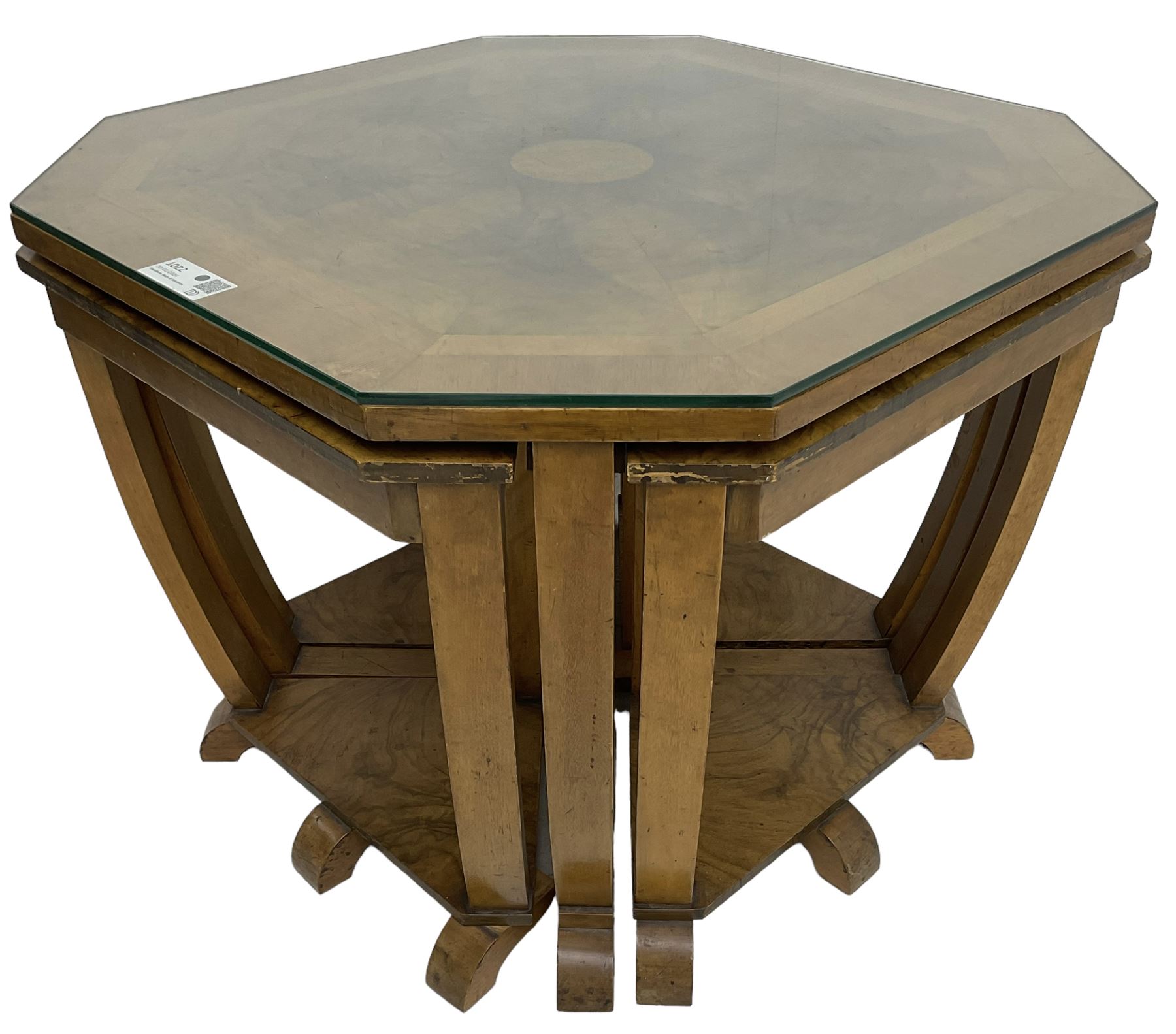 1930s Art Deco period walnut nest of tables, square canted top with segmental figured veneers forming flowerhead with birdseye maple centre, with four smaller nesting tables on arched supports united by undertier, on block feet