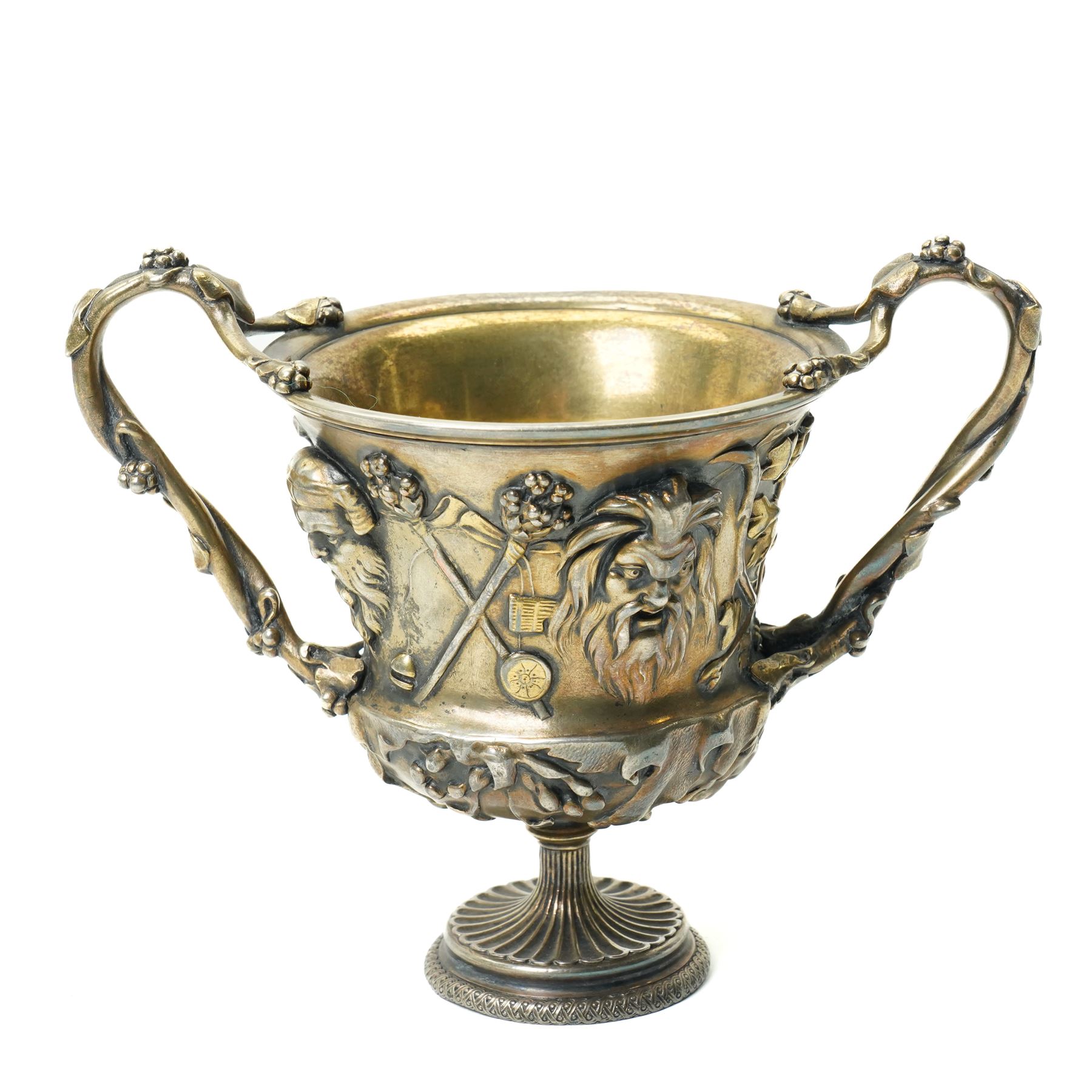 Christofle 'Tresor d'Hildesheim' facsimile gilt metal two handled cup decorated with masks, leaves etc H13cm and a bowl from the same collection with two handles and a raised pattern of leaves on a pedestal foot D19cm (2) 