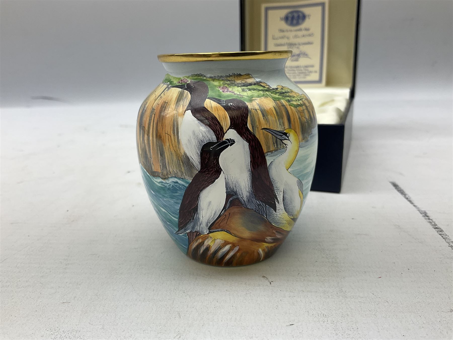 Limited edition Moorcroft enamel vase, decorated in the Lundy Island pattern, with certificate signed by the artists, no 58/75, in fitted box