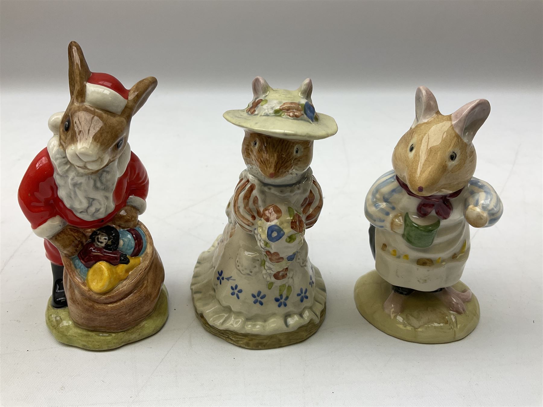 Fifteen Royal Doulton Brambly Hedge figures, comprising Wilfred Toadflax, Dusty Dogwood, Mrs Toadflax, Mr Apple, Primrose Woodmouse, Lord Woodmouse, Poppy Everbright, two Lady Woodmouse, two Old Mrs Everbright, Mr Toadflax, Mrs Apple, Santa Bunnykins and Bunnykins, together with three Royal Albert Wind in the Willows figures comprising Ratty, Badger and Mole, all with printed marks beneath (18)