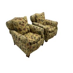 Pair late 19th century armchairs, upholstered in pale yellow floral pattern fabric, on compressed bun feet with castors