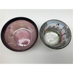 Two Eisch studio glass bowls, the first example hand painted with a landscape of trees, the second example decorated with black spirals upon a pink ground, each marked beneath, tallest example H7cm