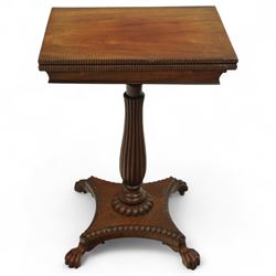 William IV mahogany folding card table of unusually small proportions, rectangular swivel top with gadrooned edge, raised on a slender tapered reeded column over quatreform base with gadrooned border, terminating in carved lion paws feet