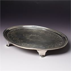 George III Irish silver oval teapot stand engraved with garlands scrolls and central crest on shaped supports L20cm Dublin 1802 Maker possibly Richard Sawyer