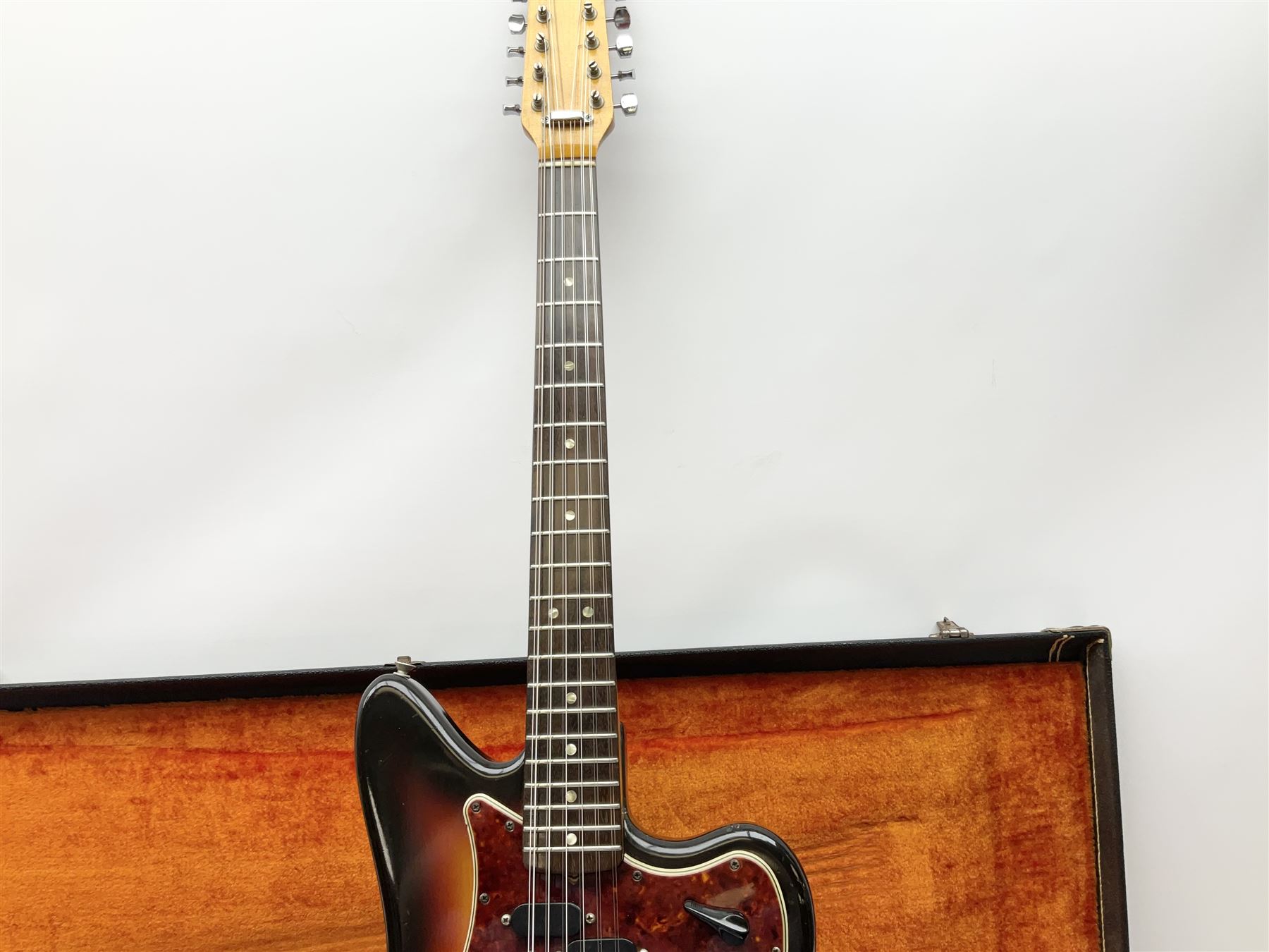 Fender three-tone Sunburst 12-string electric guitar c1965/6 Fullerton USA, with alder body and maple neck, the Indian rosewood fretboard with twenty-one frets and pearloid dot markers, fender electric XII bridge, F-stamp tuners (non-original), two split single coil pick-ups, master volume and tone and four-way switch, serial no.129730, L108cm; in original Fender case bearing label for Rivington Guitars New York with copy of original invoice; together with GuitarKes set-up and service certificate dated October 2021
