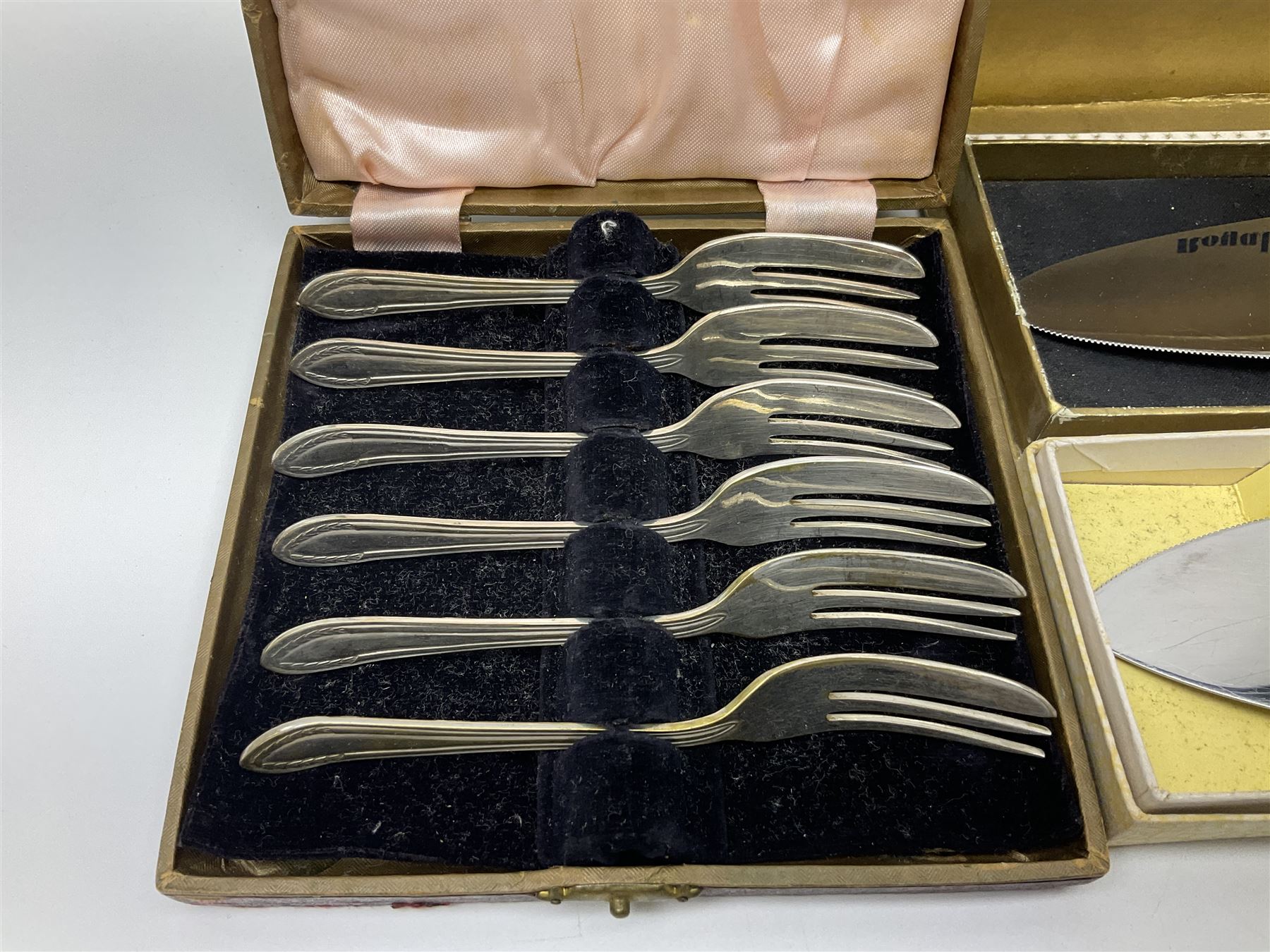 Collection of silver-plated cutlery including cased set of six EPNS cake forks, Royal Crown Derby pie server, sugar tongs, ladles, etc