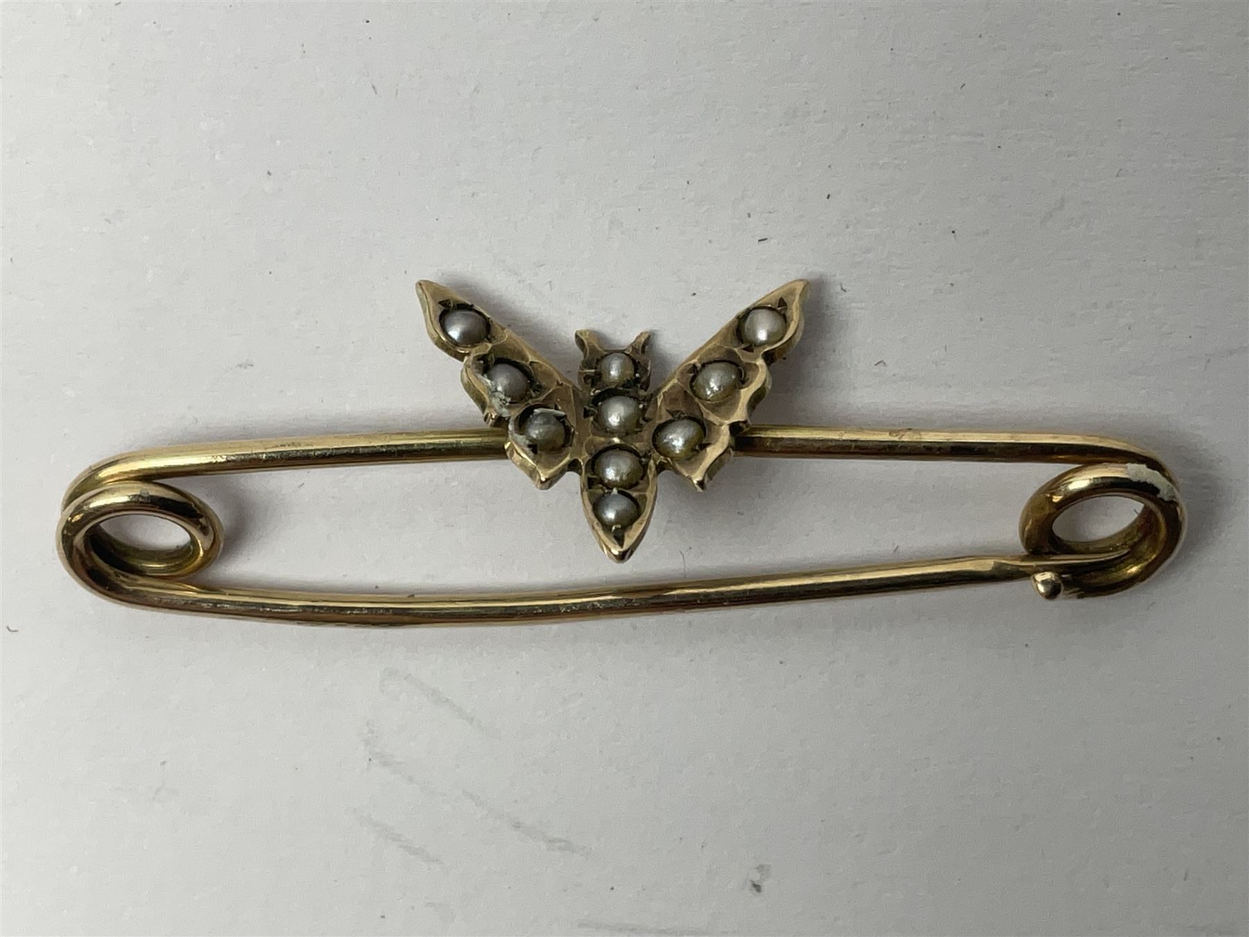 9ct gold pear butterfly brooch, 9ct gold stone set ring and an silver fob watch, all stamped or hallmarked 