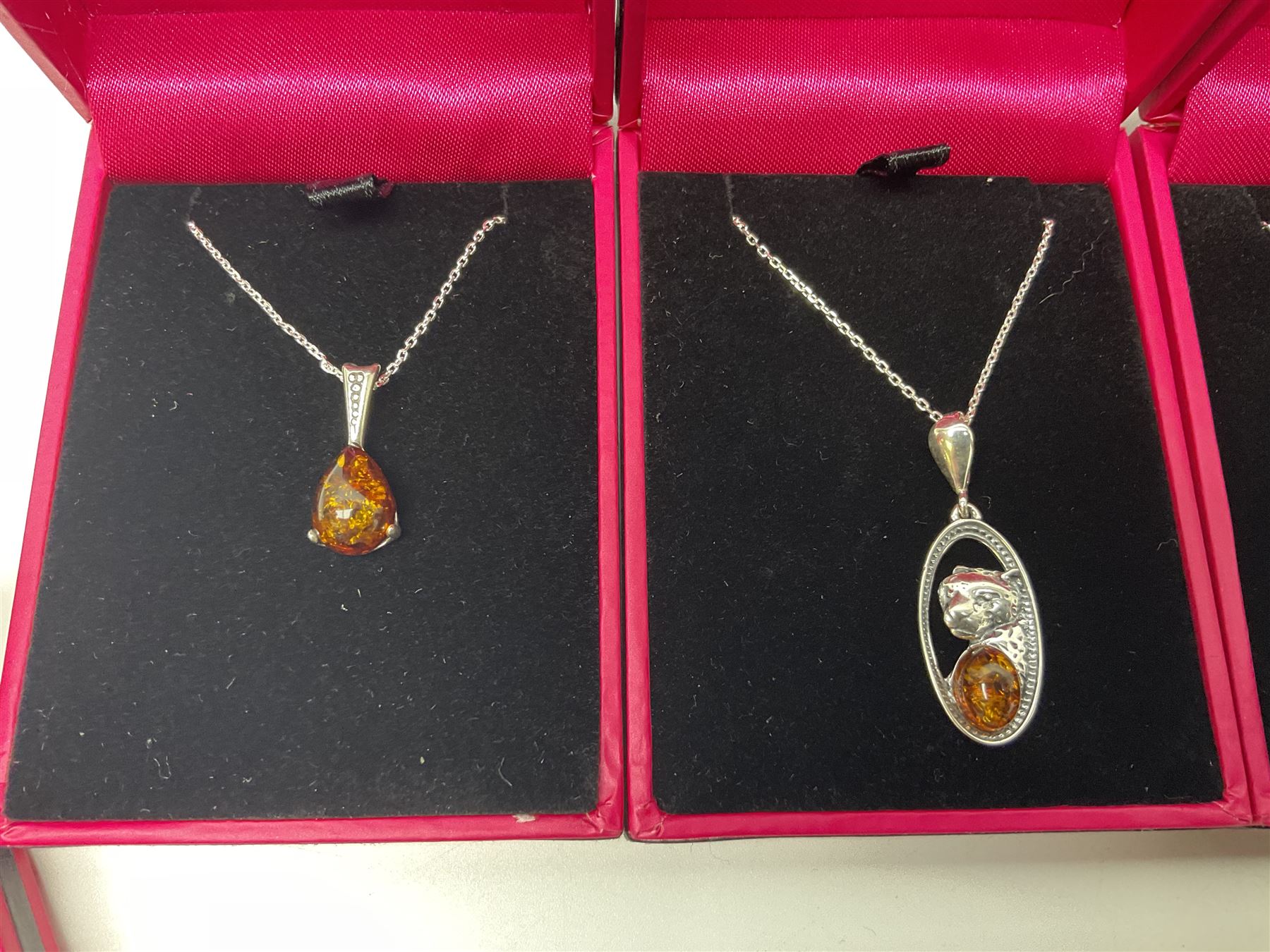 Six silver Baltic amber pendant necklaces, including dinosaur and butterfly designs, all stamped 925 