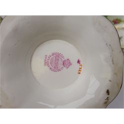 19th century Minton tea set, comprising twelve teacups, eleven saucers, fifteen side plates, cream jug, slop bowl, and two cake plates, decorated with panels of floral sprays, upon a green ground, heightened with gilt throughout, with printed puce mark beneath, and pattern number 5329
