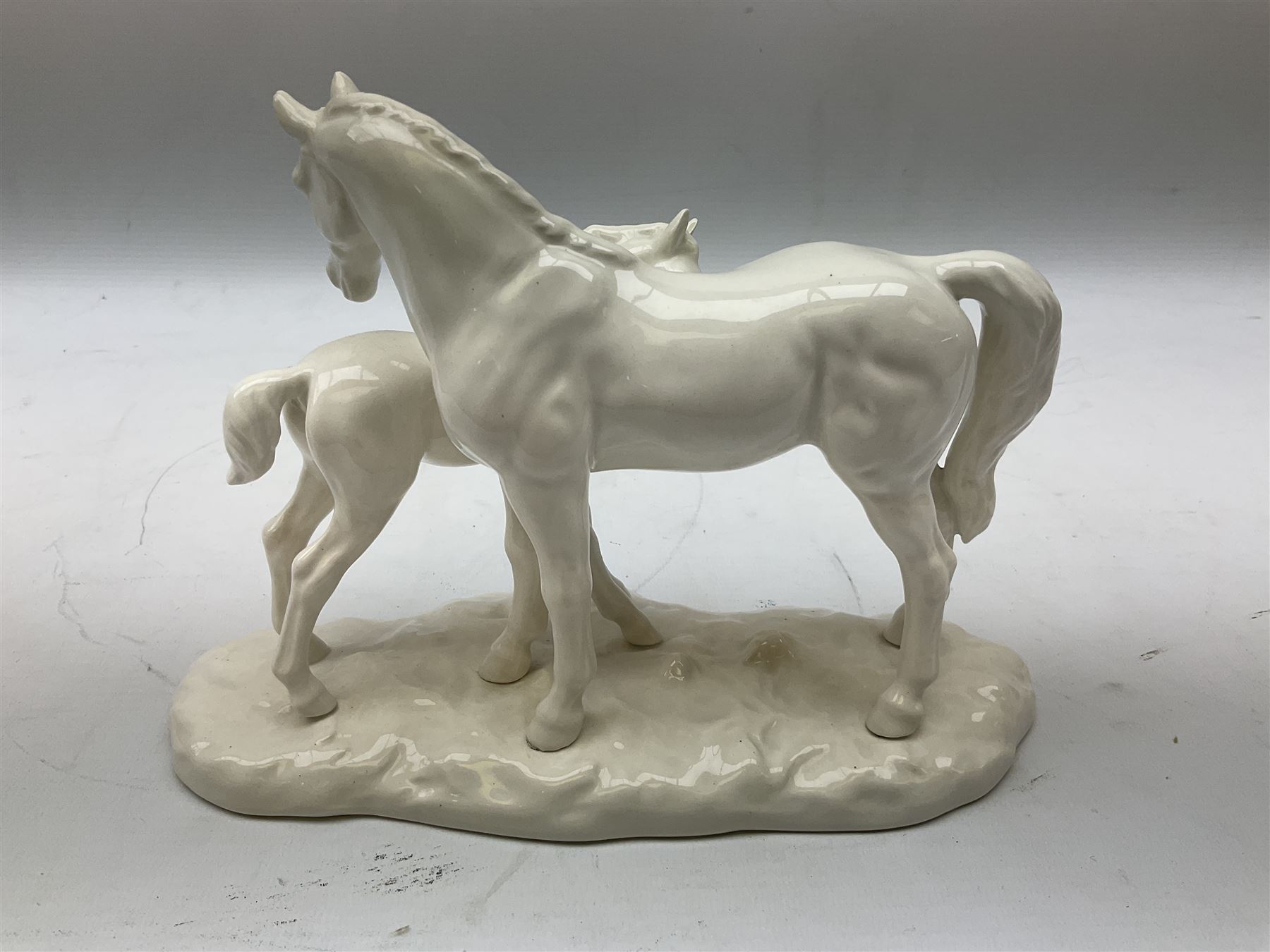 Three Royal Doulton figures, comprising Faith HN4151, Hope HN4097 and Charity HN4243, together with a horse and foal figure group