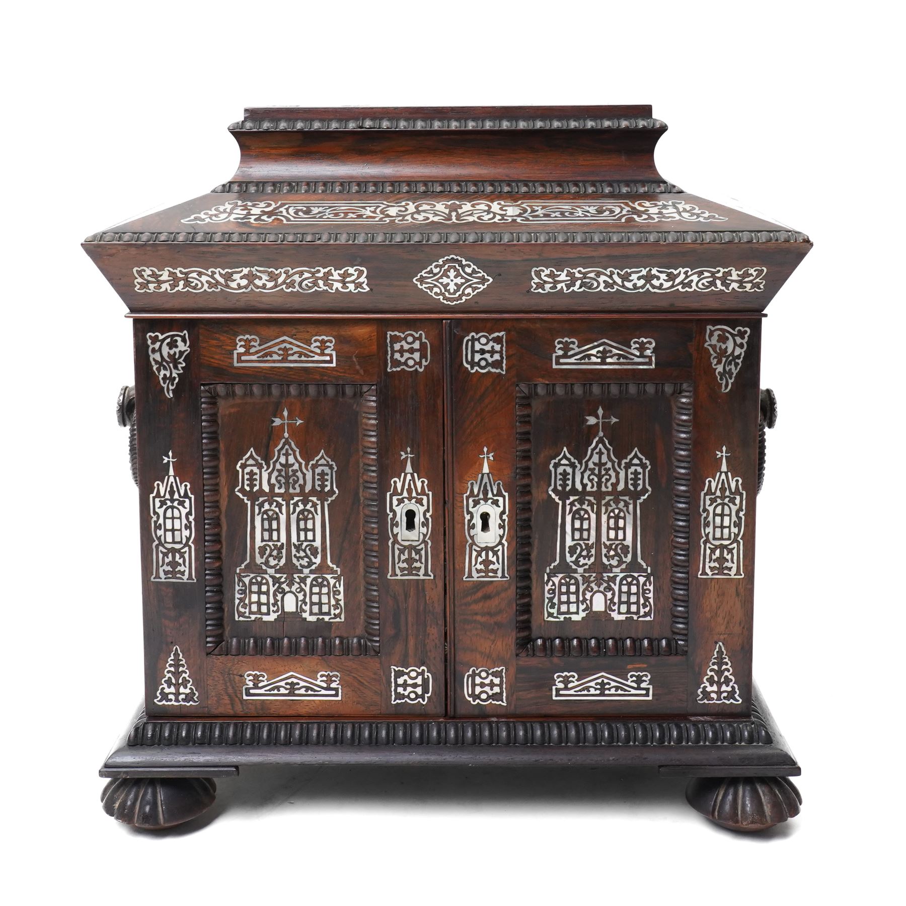 Early Victorian rosewood and mother of pearl inlaid sewing, jewellery, and writing casket  with hinged lid, the upper section fitted for sewing implements, above four drawers, the bottom drawer with writing slope and on compressed fluted feet H36cm x W34cm