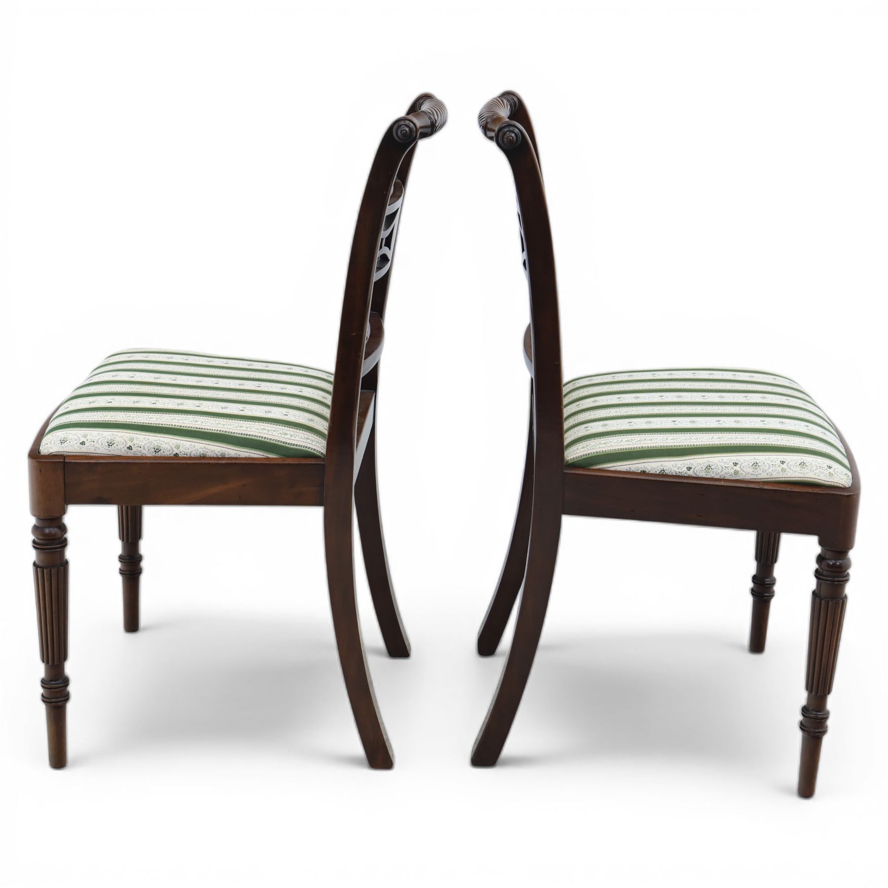 Pair of 19th century mahogany dining chairs, the wrythen top rail above a pierced splat and reeded side supports, above a white and green upholstered drop in seat, upon turned and reeded front and plain back legs