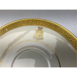 Minton part dinner service, decorated with gold rim and crest, pattern number K154, comprising four dinner plates, five dessert plates, four side plates, two smaller side plates, three saucers, and two teacups, in one box 