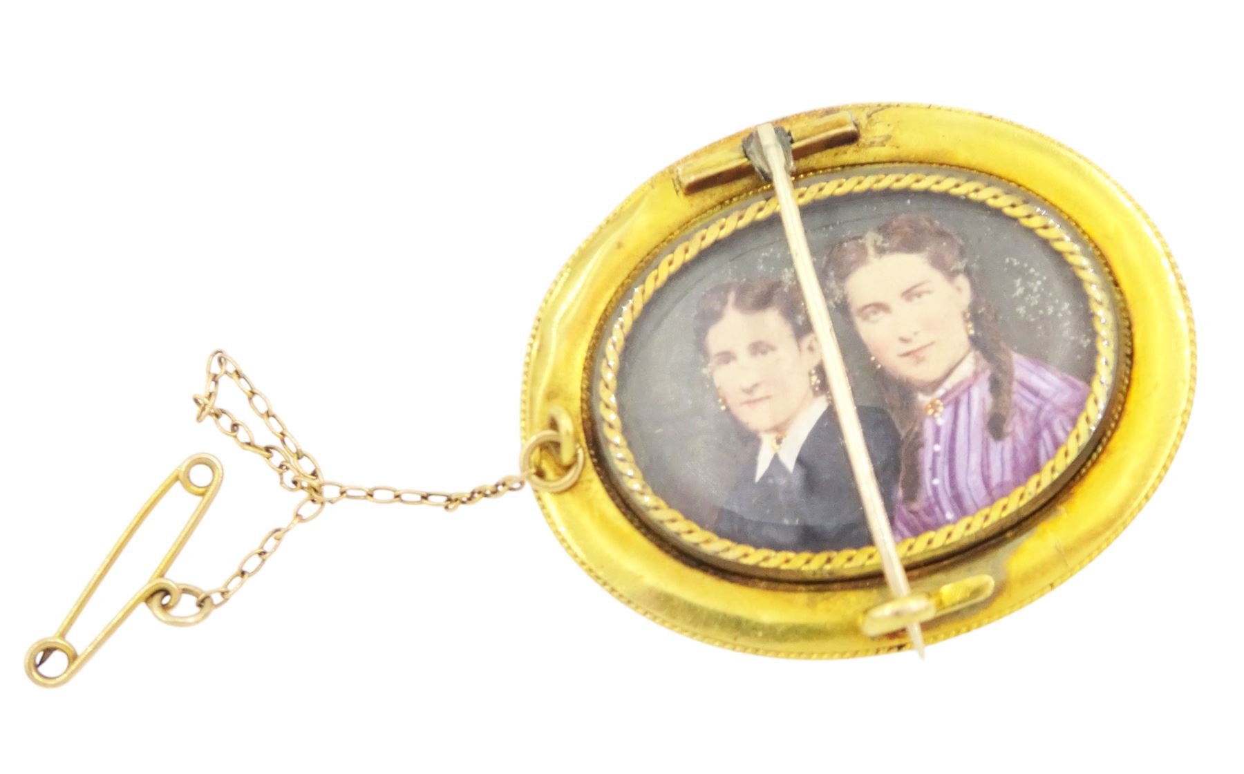 Victorian gold hinged locket brooch, the monogrammed black enamel front revealing hairwork glazed locket and an Victorian 18ct gold Etruscan design brooch