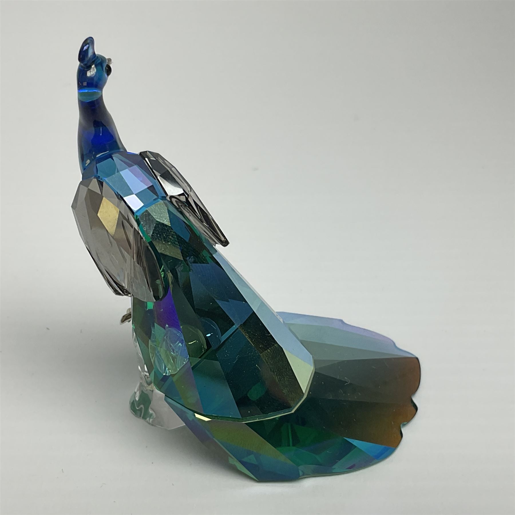 Swarovski Crystal SCS Edition peacock, Arya, together with a Swarovski Crystal peacock, perched on rock and small Swarovski Crystal sign, with peacock motif, tallest H11cm