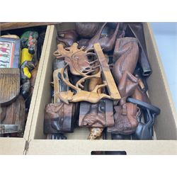 Collection of carved wooden items, to include wall hanging busts, wooden panels, animals, wooden panels, etc, in four boxes 