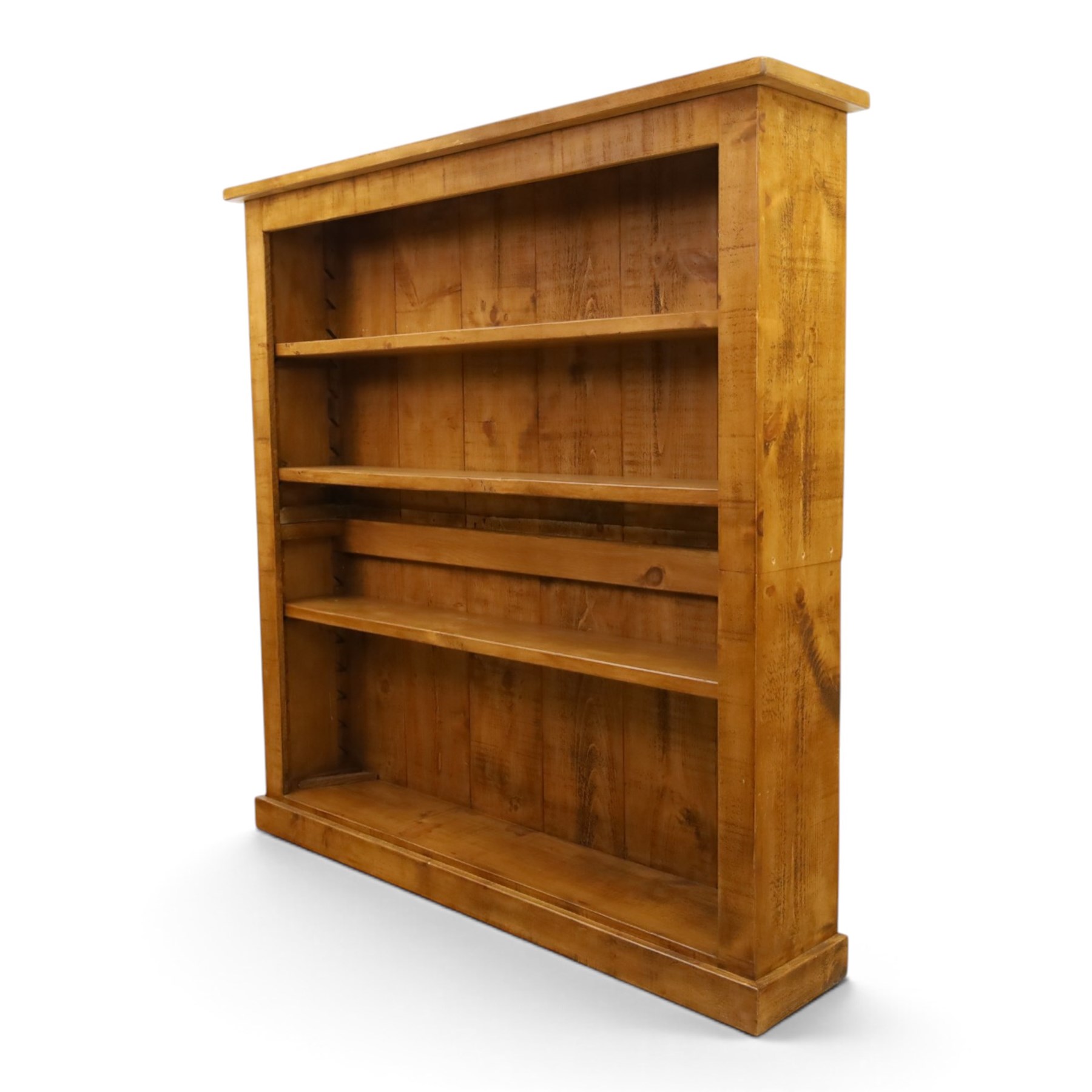 Indigo Furniture - large rustic oak open bookcase, with four adjustable shelves, above a plinth base 