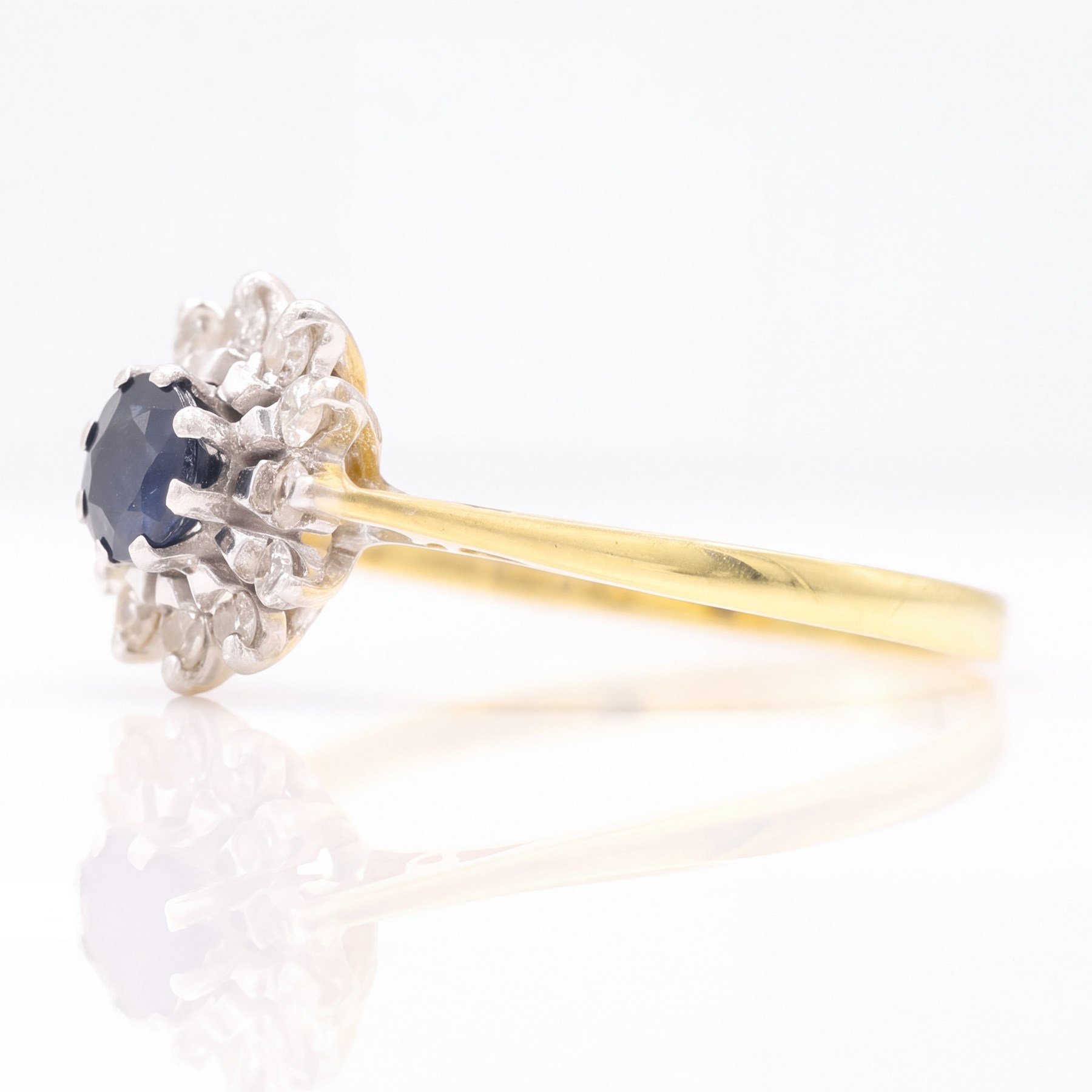 18ct gold sapphire and diamond cluster ring, single round cut sapphire surrounded by twelve single cut diamonds, Birmingham 1985