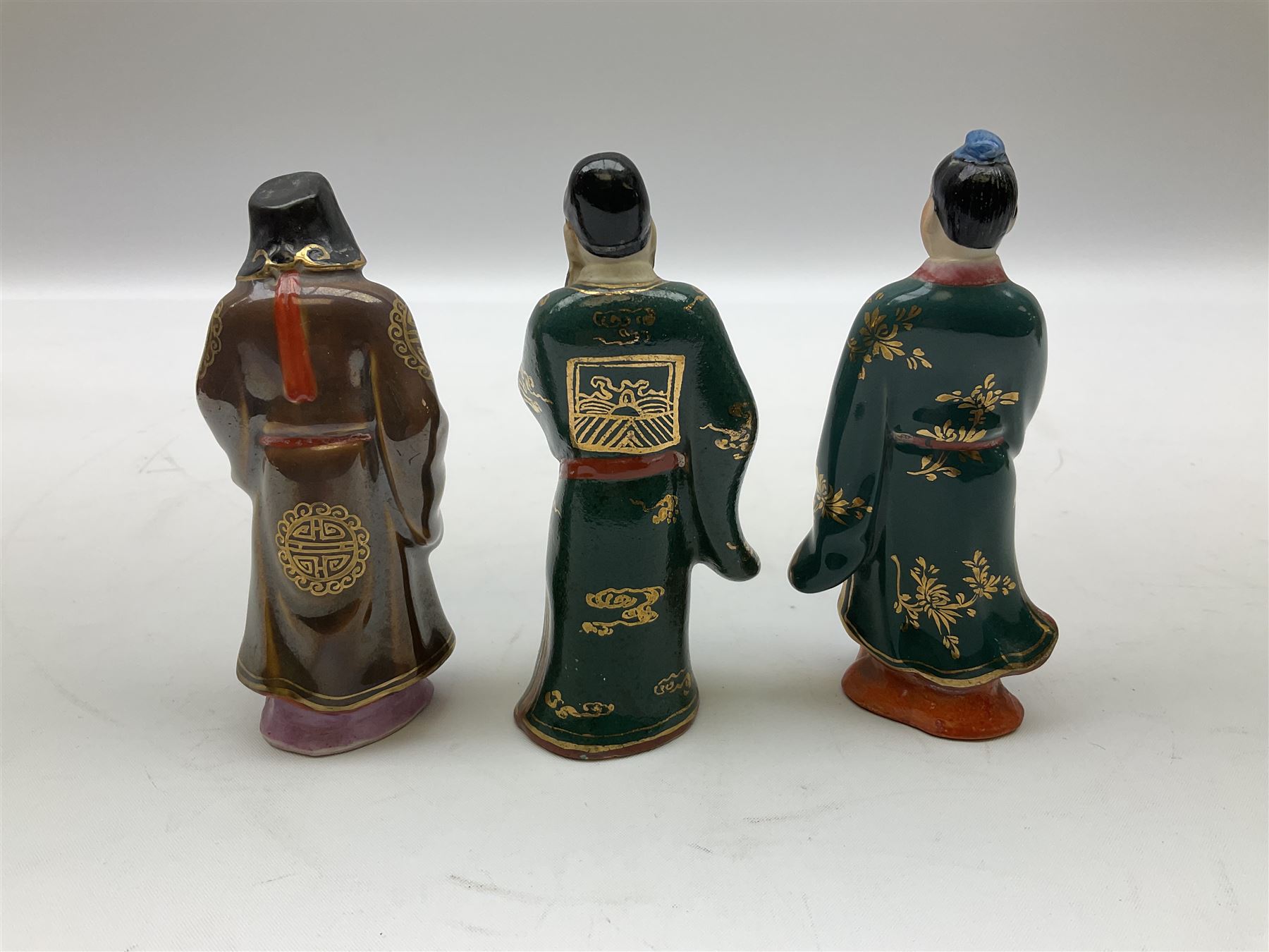 Japanese parquetry puzzle box L12cm; another Japanese puzzle box with marquetry top of Mount Fuji; eleven graduated Chinese figures including immortals; and Chinese figure of a lady standing on a hardwood base next to a horn table (14)