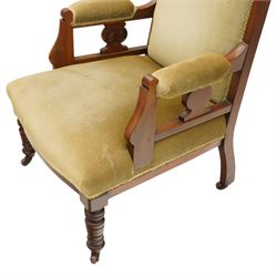 Pair of late Victorian mahogany carved open armchairs, with carved cresting rail, above upholstered seat, back and arms, raised on turned supports terminating in castors