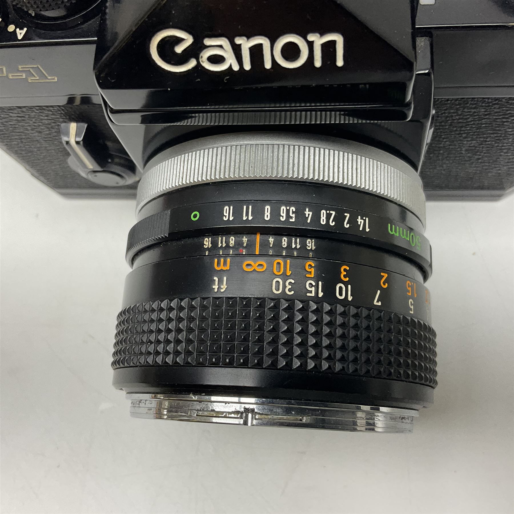 Canon F1n camera body, serial no. 572972, with 'Canon FD 50mm 1:1.4' lens, serial no. 246665, with leather case 