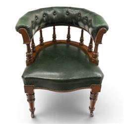 Late Victorian mahogany framed Captains tub desk chair, the green leather upholstered cresting rail over turned spindle supports over a sprung seat, raised on front turned supports terminating to ceramic castors