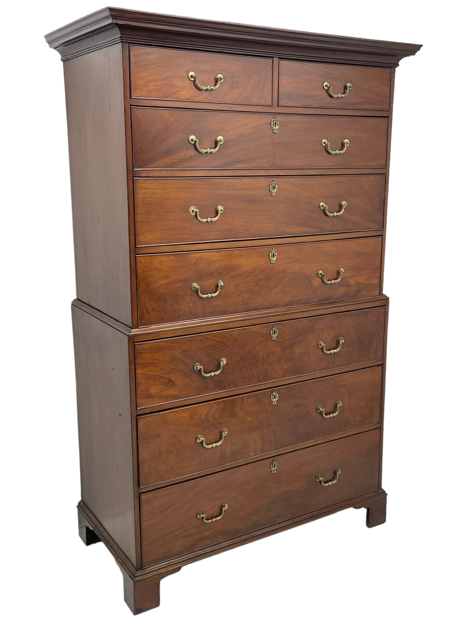 George III figured mahogany chest-on-chest, projecting moulded cornice over two short and six long graduating cock-beaded drawers, on bracket feet