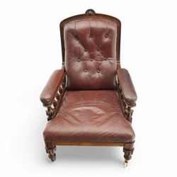 Late Victorian mahogany open armchair, arched cresting rail decorated with turned roundel, upholstered in buttoned burgundy leather, the upholstered arms on turned and lobe carved balustrade, turned and lobe carved front feet with brass and ceramic castors 