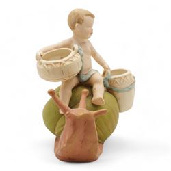 Royal Dux figural posey holder, modelled as a boy with baskets riding a snail, H16.5cm