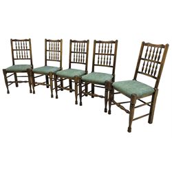Set of five Lancashire design elm spindle back chairs, shaped cresting rail over two rows of five spindles, upholstered drop-on seats, on turned front supports united by turned stretchers  