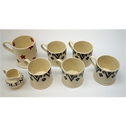 Five Emma Bridgewater mugs decorated in a stylised black band, H7cm, together with a small jug detailed Stolen Milk, H6cm, and a further mug decorated with red stars and detailed I Love Linthwaite, H9.5cm. (7). 