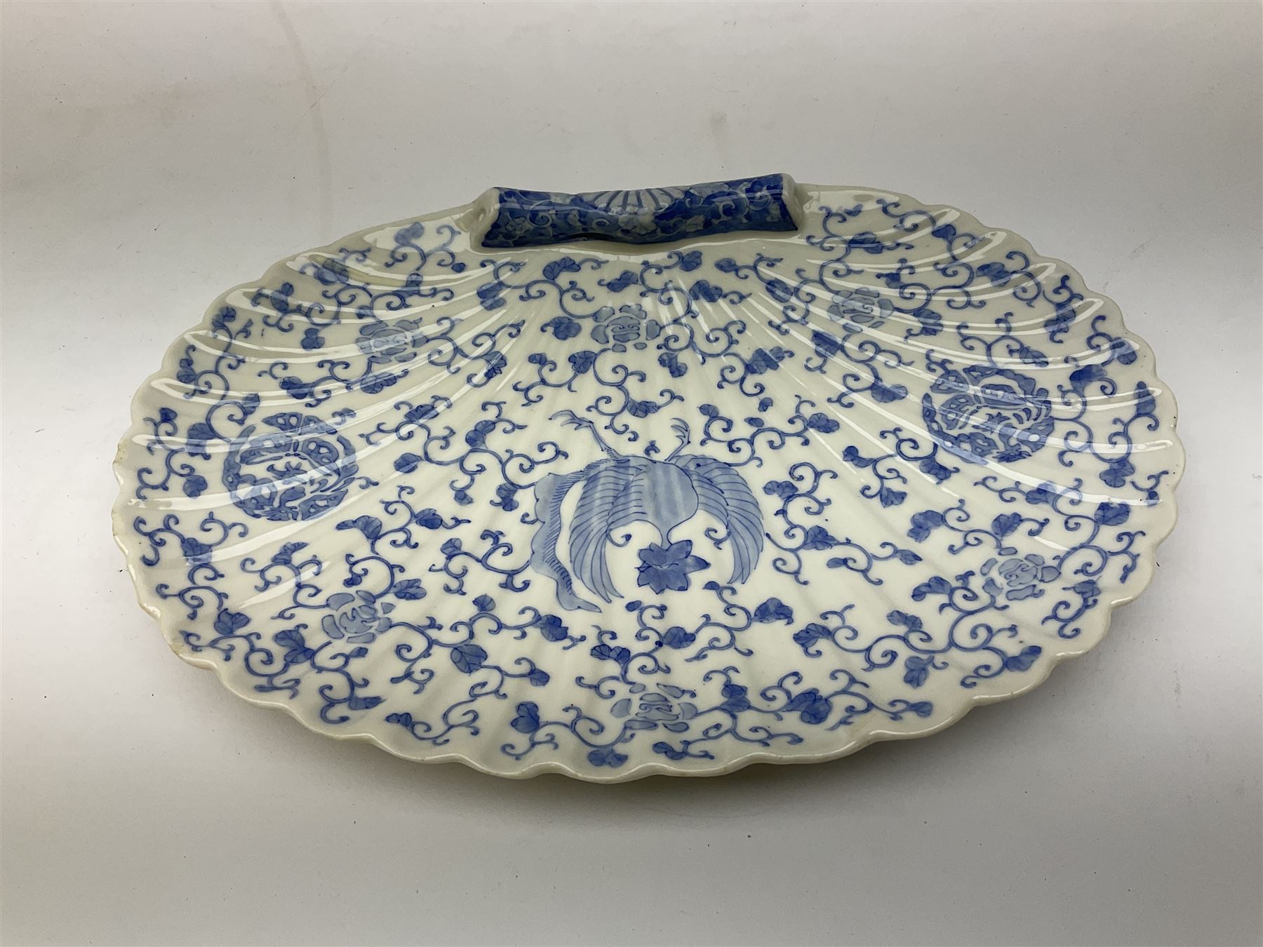 Japanese Hirado blue and white porcelain censer in the form of a Lion Dog, together with a Hirado porcelain shell shaped dish, centrally decorated with an exotic bird flanked by two roundels on floral scroll ground, censer H13cm