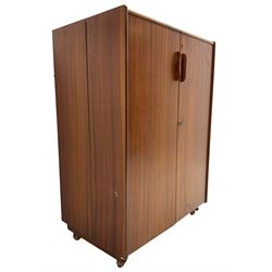 Mummenthaler & Meier - mid-20th century circa. 1960s teak 'Magic Box' folding desk cabinet, the cabinet opens to reveal shelves, writing desk, document holders and lamp, on castors