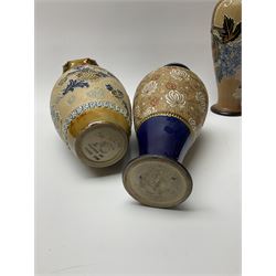 A pair of Royal Doulton Slaters Patent vases, decorated with press moulded and foliate painted bands, H26cm, a further pair of Doulton Lambeth Slaters Patent vases with crimped rims, H21.5cm, and a further single Royal Doulton Slaters Patent vase, H27cm.  